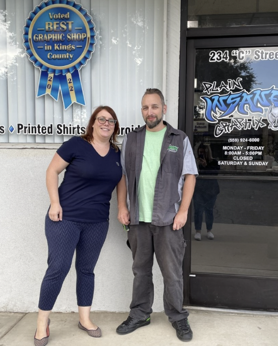 Plain Insane Graphix showcases their Best In Kings County award with a window cling